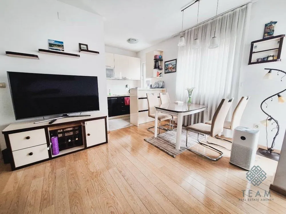Living room with dining area and TV.