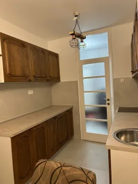 Kitchen with wooden cabinets and a built-in sink. - image 6