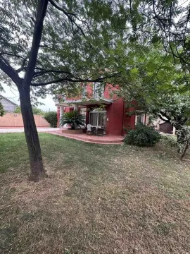 View of the yard and the facade of the house surrounded by greenery and trees. - image 4