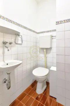 Small bathroom with white tiles, washbasin and toilet. - image 18