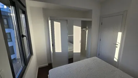 Bedroom with a bed, wardrobe and window. - image 5