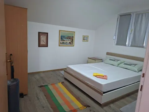Bright bedroom with a double bed, wardrobe, and window. - image 6
