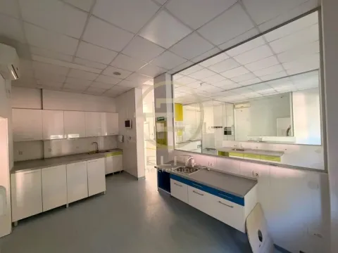 Spacious white kitchen with counter elements and a large window. - image 3