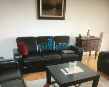 Living room with black leather sofa set, coffee table, and chest of drawers. - image 2