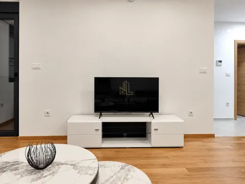 Living room with a TV and a TV unit. - image 4