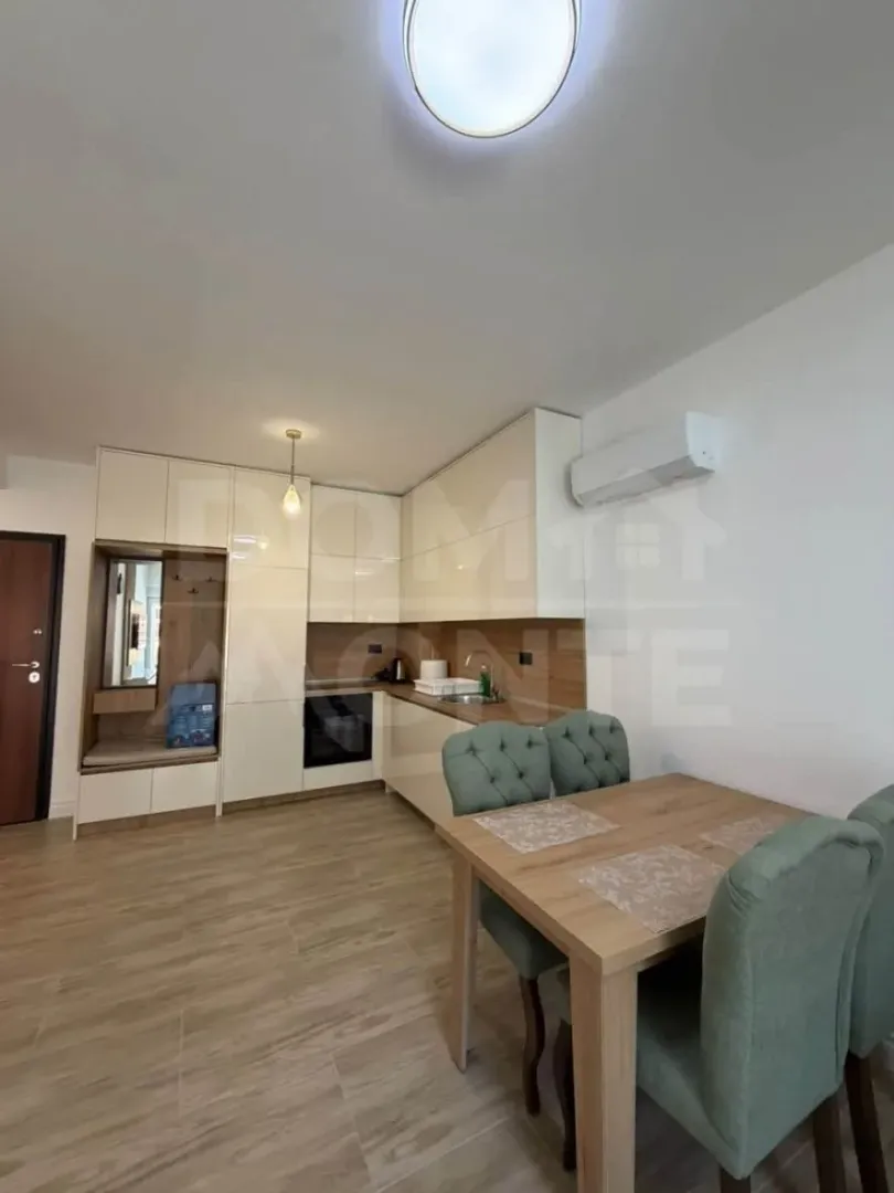 Modern kitchen with dining area and built-in appliances.