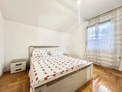 Spavaća soba sa bračnim krevetom i drvenim podom. - image 8