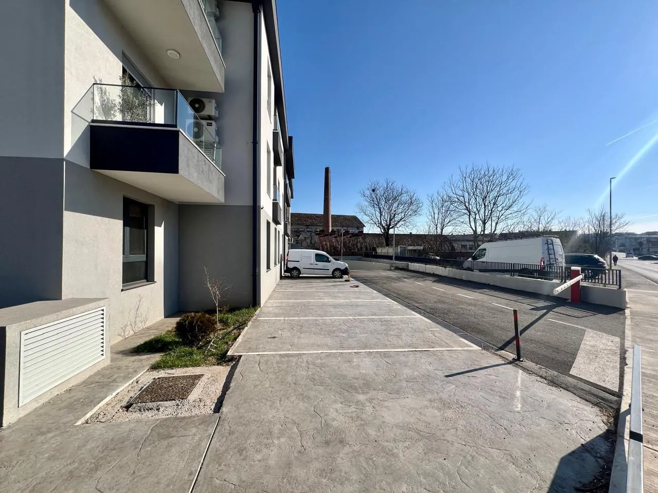 Exterior of the residential building with parking spaces.