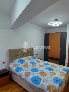 Furnished bedroom with a double bed and a wardrobe. - image 7