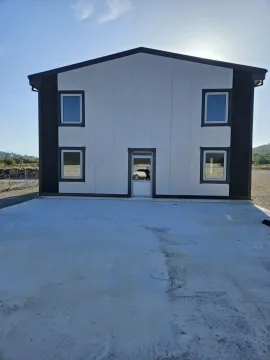 Exterior view of a new modular house with a concrete driveway in front. - image 7