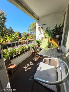 Namešten balkon sa stolom, stolicama i dosta zelenila. - image 11