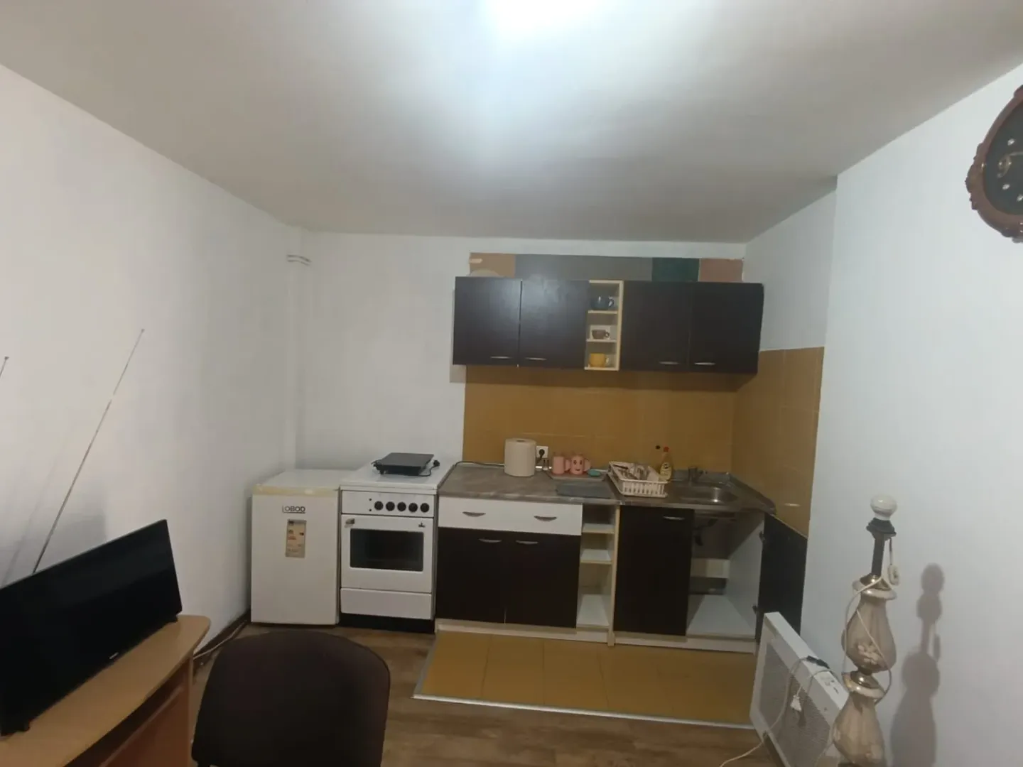 Smaller kitchen with cabinets and home appliances.