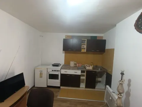 Smaller kitchen with cabinets and home appliances. - image 4