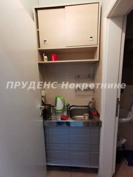 Small kitchen with a sink, workspace, and wall-mounted cabinets.