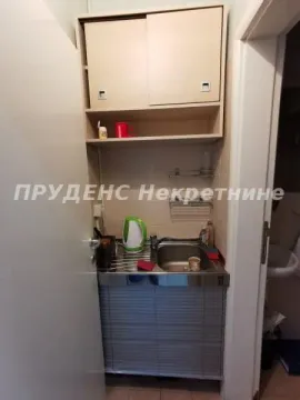 Small kitchen with a sink, workspace, and wall-mounted cabinets. - image 7