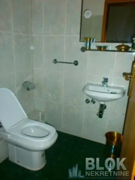Smaller bathroom with a toilet and a sink. - image 2