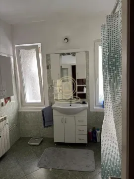 Bathroom with a washbasin, mirror, and a shower with a curtain. - image 9
