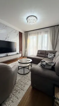 Modern and bright living room with a sofa and TV. - image 3