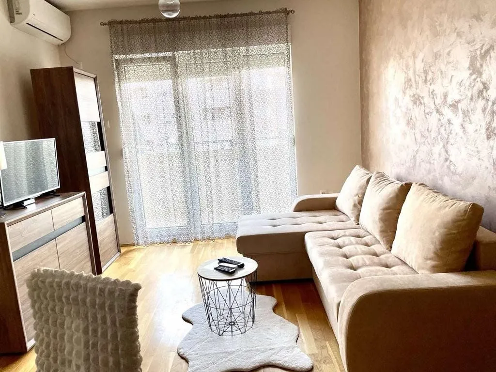 Living room with a corner sofa, coffee table and TV.
