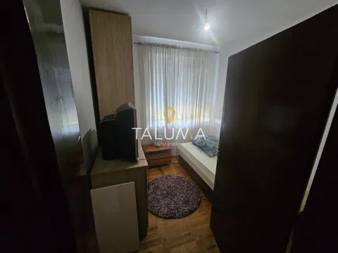 Smaller bedroom with a bed, wardrobe, and television. - image 4