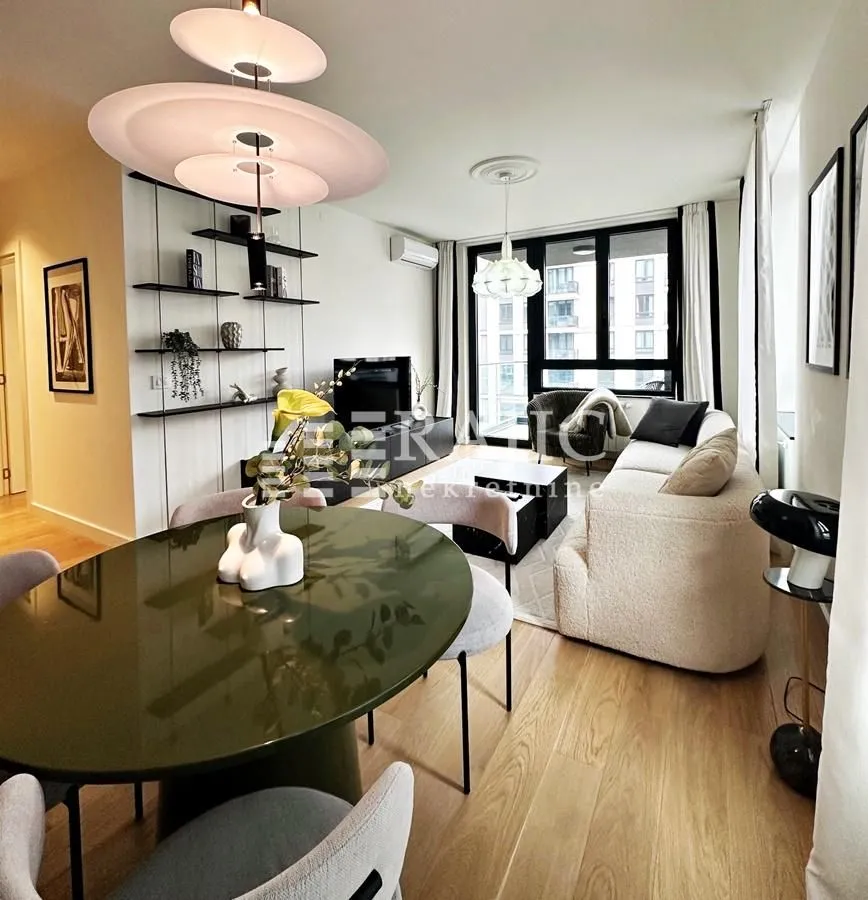 Modern living room with a dining area and elegant furniture.