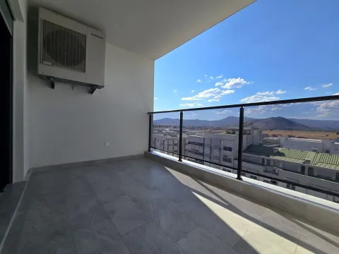 Spacious covered terrace with ceramic flooring and a view of the city and hills. - image 6