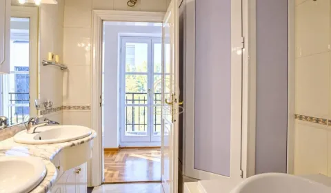 View from the bathroom towards the hallway and balcony doors. - image 4