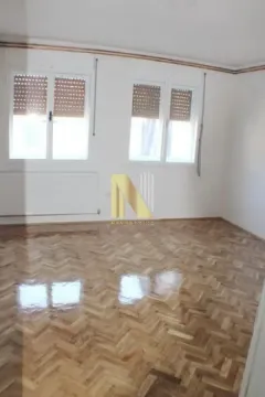 Empty room with parquet flooring and white walls. - image 4