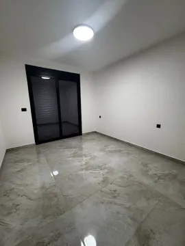 Empty room with ceramic tiles and balcony doors. - image 5