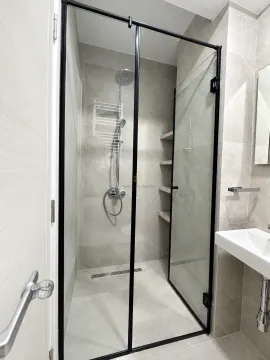 Modern bathroom with a walk-in shower and a washbasin. - image 6
