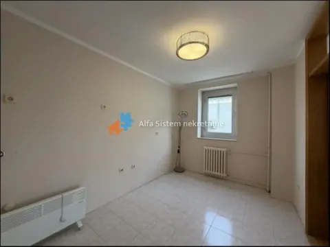 Empty room with floor tiles, a window, and a radiator. - image 15