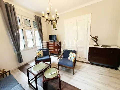 Furnished living room with seating area and curtained windows. - image 3