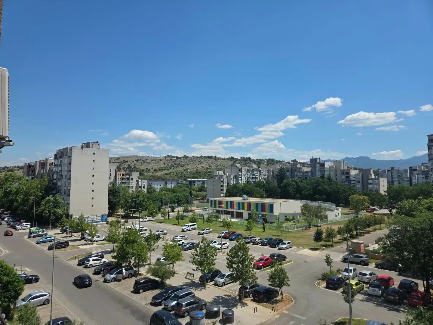 View from the terrace on the city neighborhood and parking lot.