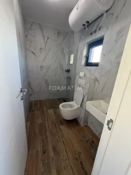 Modern bathroom with a shower cabin, toilet, and washbasin. - image 13