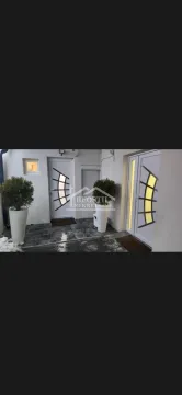 Entrance to the building with white doors and decorative planters. - image 8