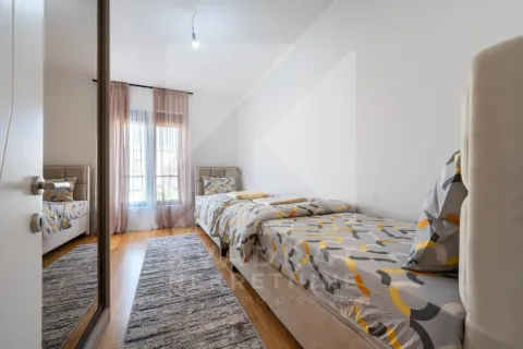 Bedroom with two single beds and a mirrored wardrobe. - image 11