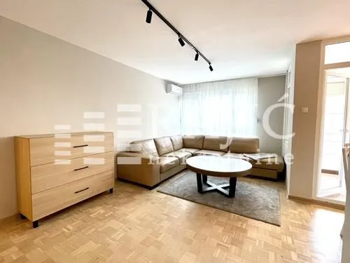 Living room with a sectional sofa, coffee table, and chest of drawers.
