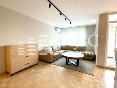 Living room with a sectional sofa, coffee table, and chest of drawers. - image 6