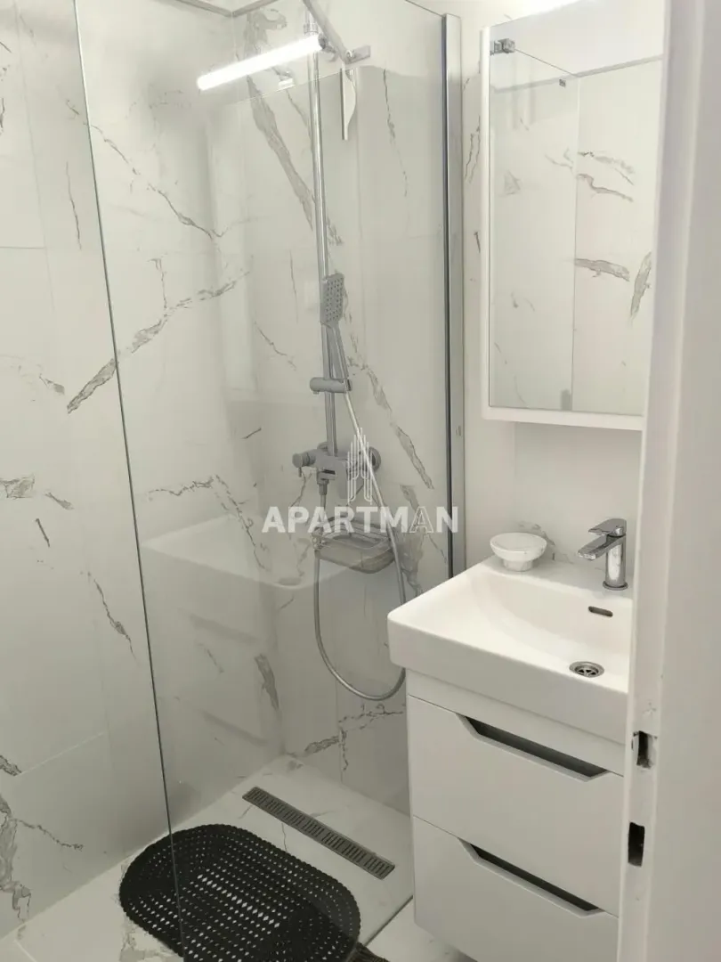 Bathroom with a walk-in shower and a vanity unit.
