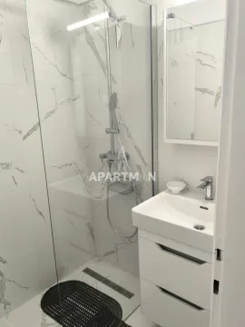 Bathroom with a walk-in shower and a vanity unit. - image 8