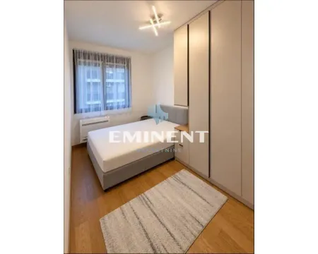 Furnished bedroom with a bed and built-in wardrobe. - image 6