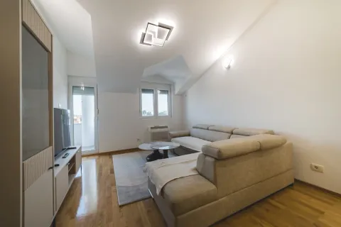 Bright living room with a sofa set, TV unit, and access to the terrace. - image 2