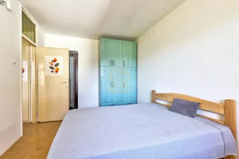 Furnished bedroom with a double bed and a blue wardrobe. - image 19