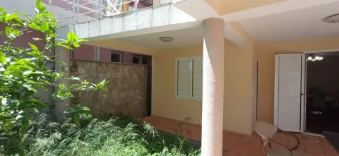 Covered terrace and yard in front of the house with greenery. - image 15
