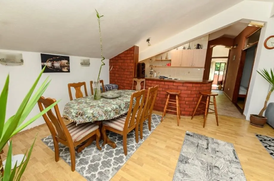 Living room with dining area and partial kitchen in the attic.