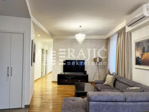 Spacious and bright living room with seating furniture and a TV. - image 2
