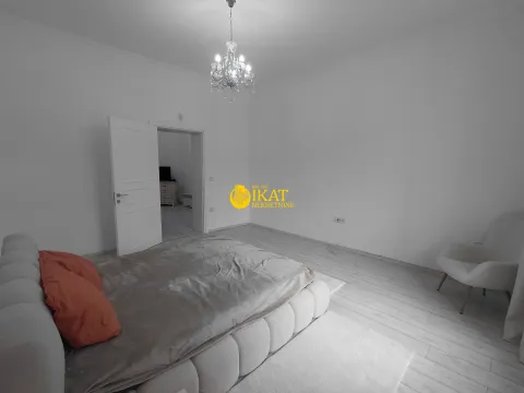 Spacious bedroom with a large double bed and an open door. - image 8