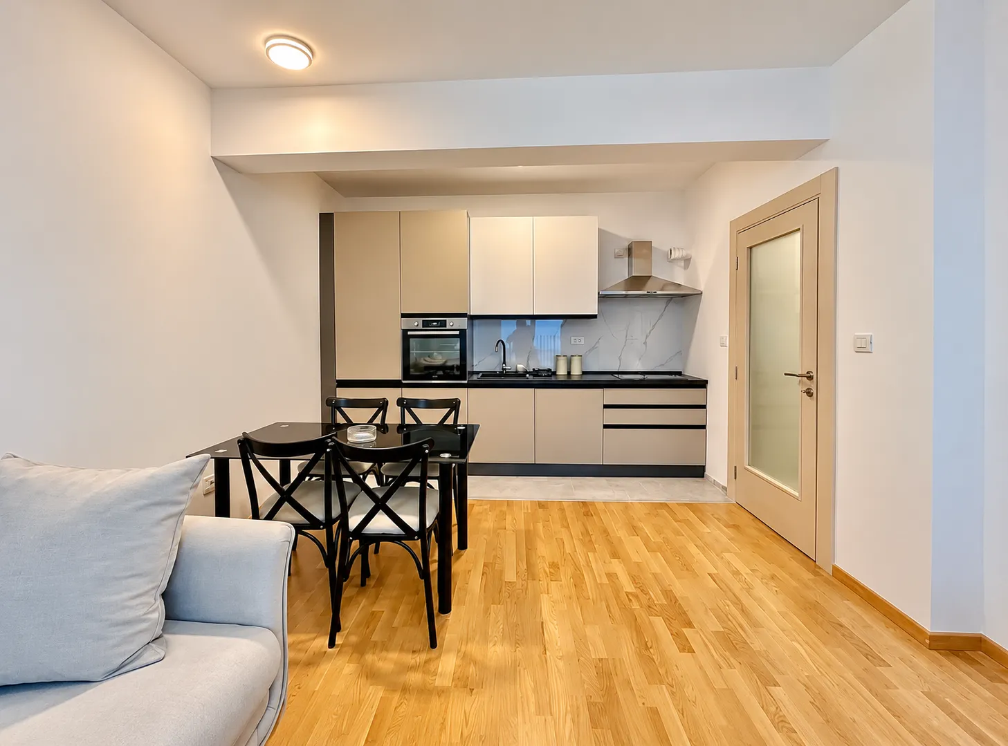 Kitchen with dining area and built-in appliances.
