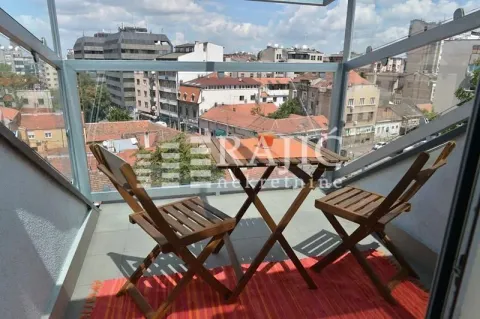 Glazed terrace with a wooden table and chairs and a city view. - image 11