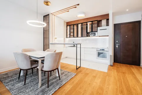 Modern kitchen with a dining area and built-in appliances. - image 2